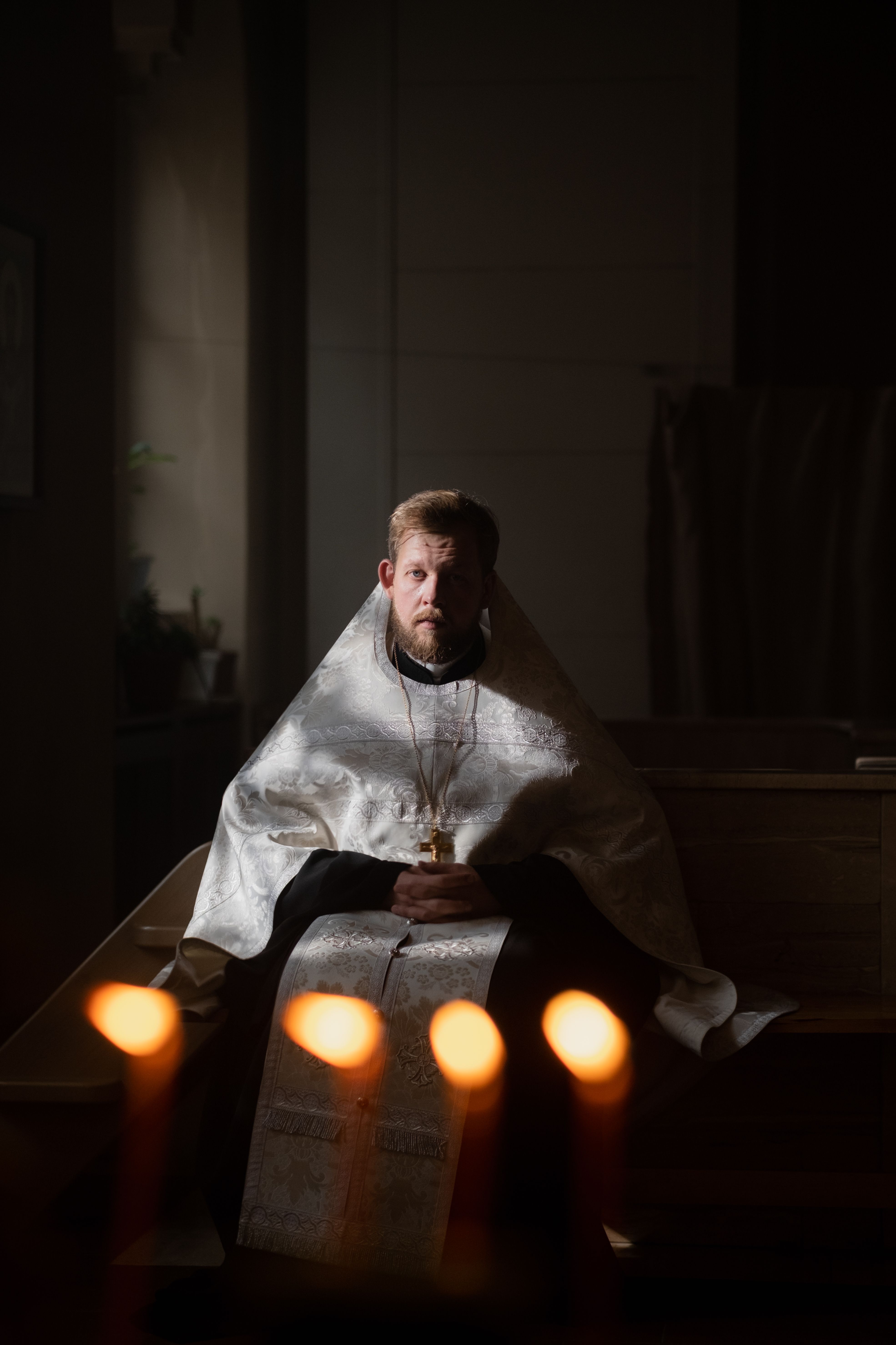 A townsperson keeps a candlelit vigil through the Long Night