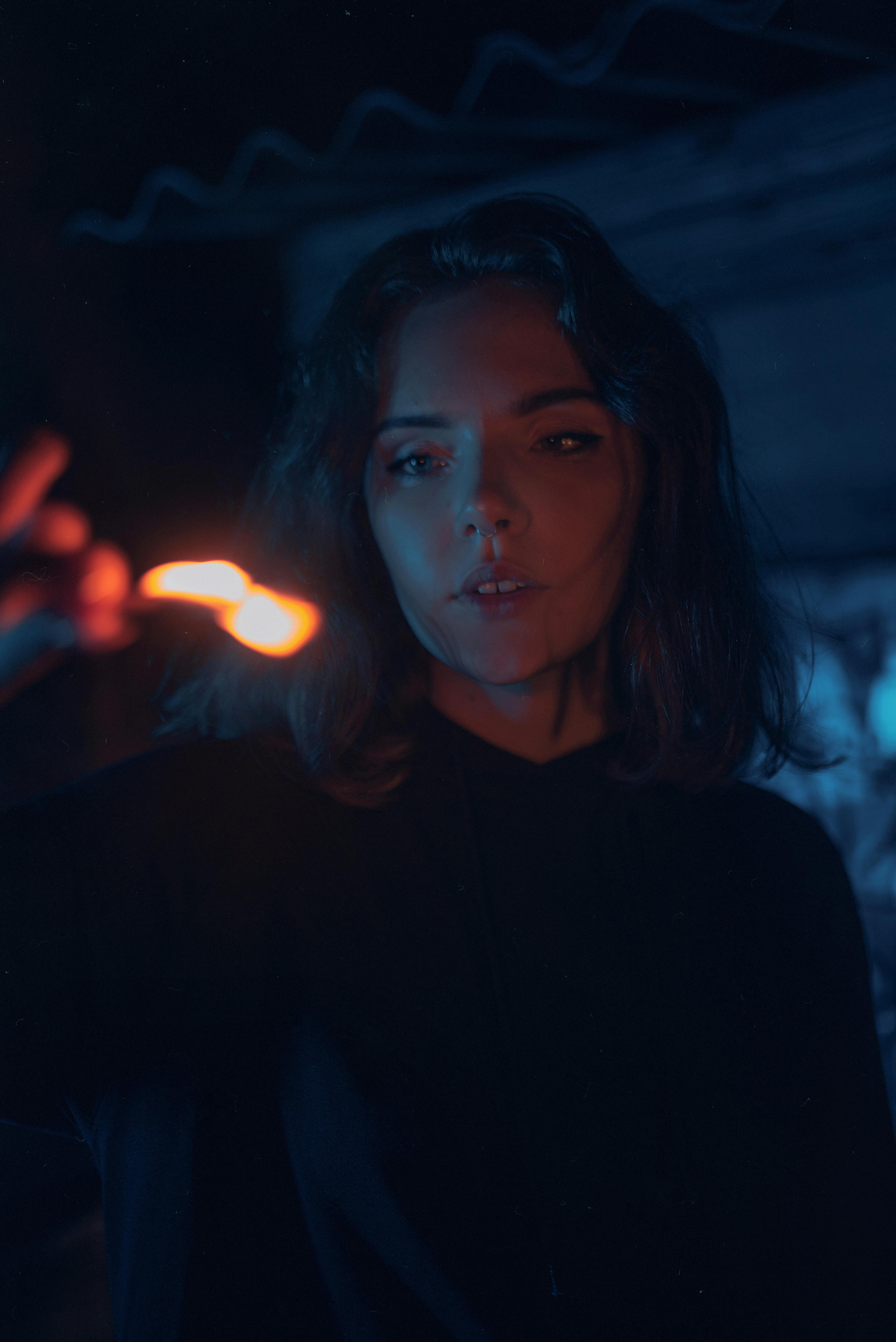 A townsperson's face caught in the dark — but is she still human?