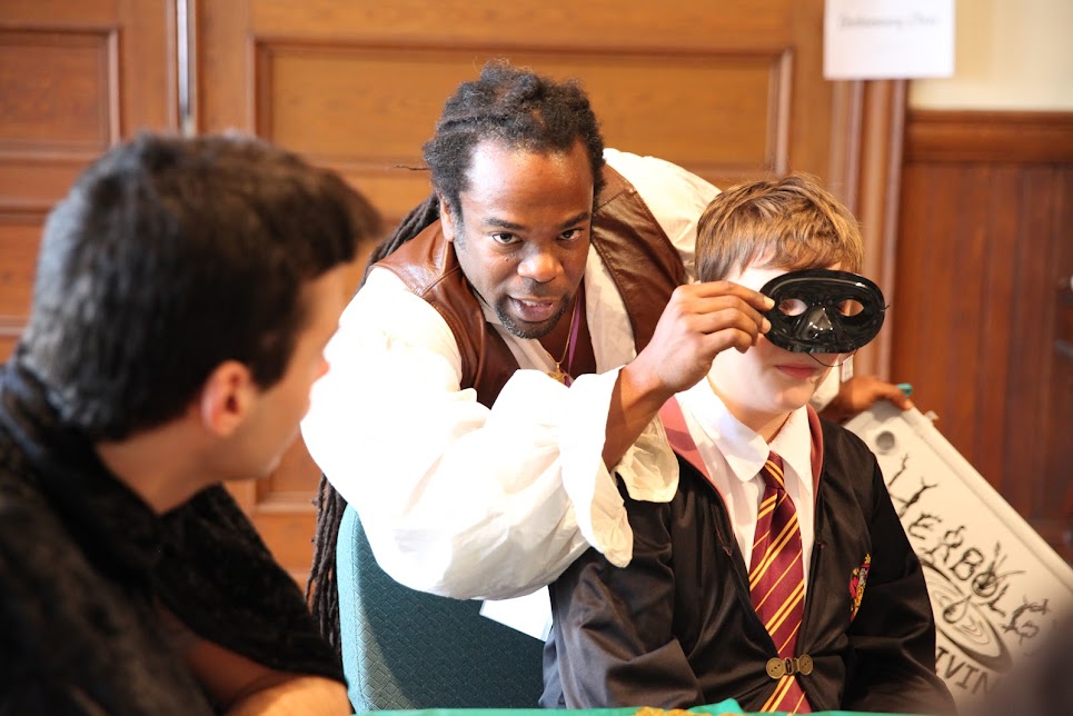 Staff member mentoring students in costume