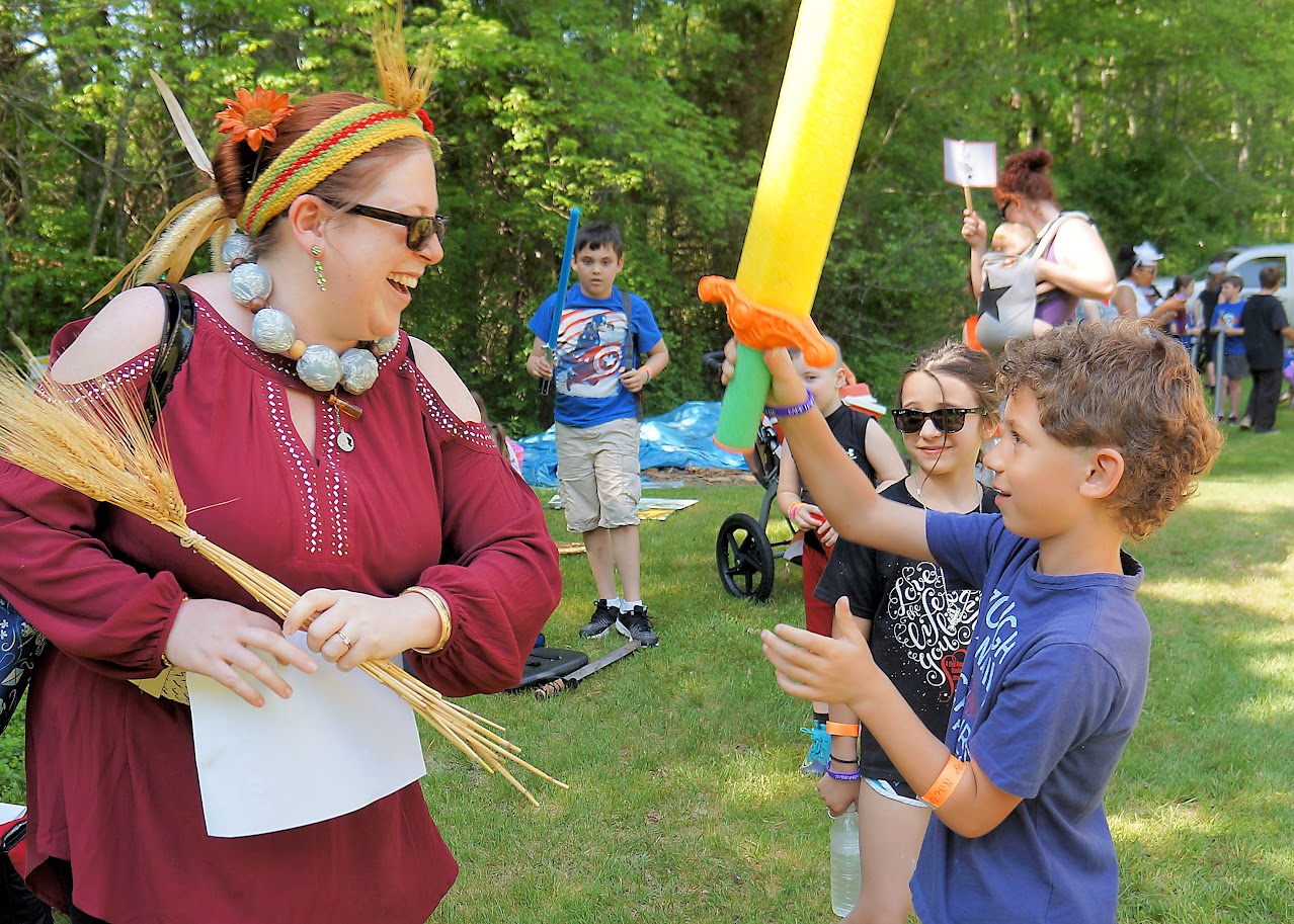 Teens engaged in foam sword combat