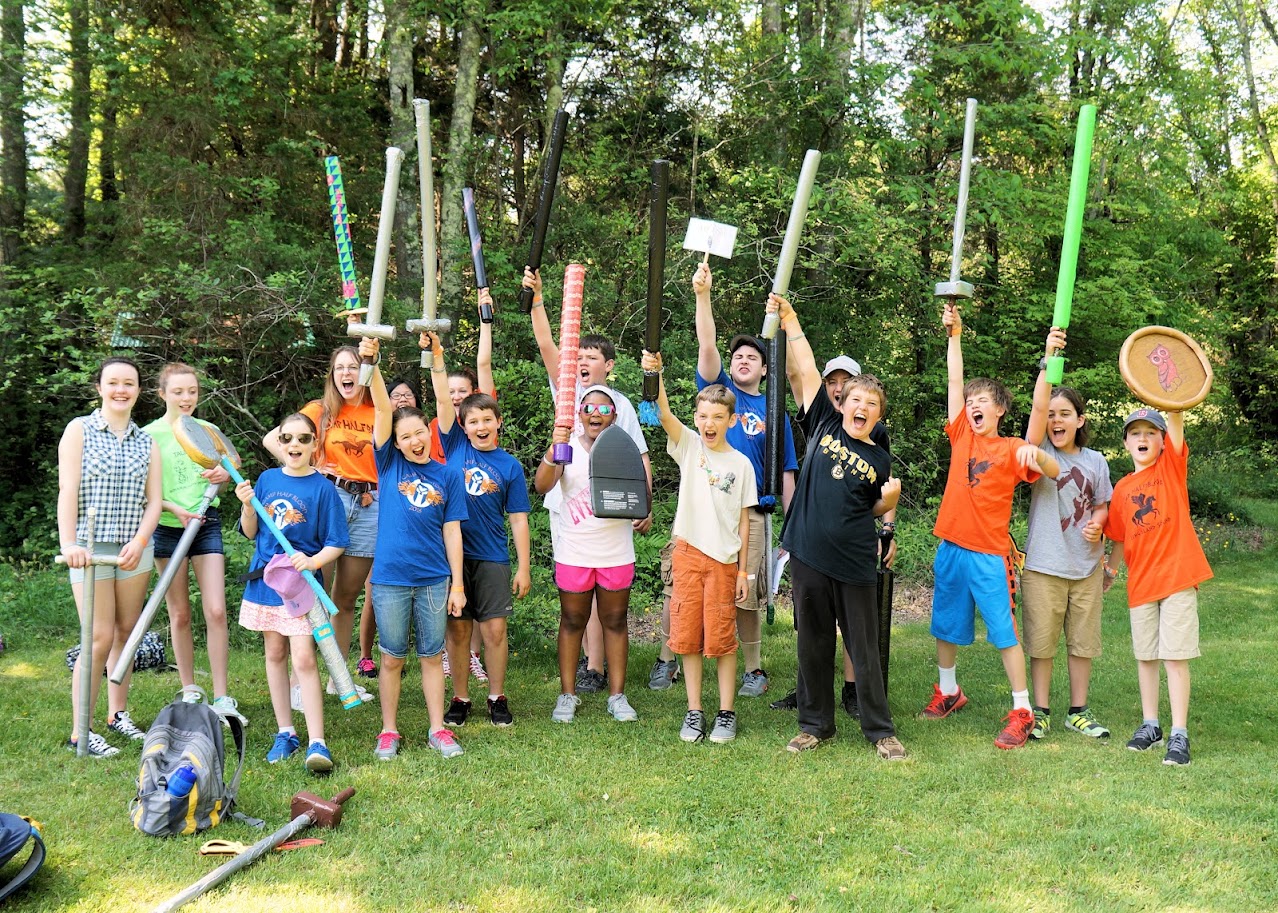 Campers celebrating with foam weapons raised