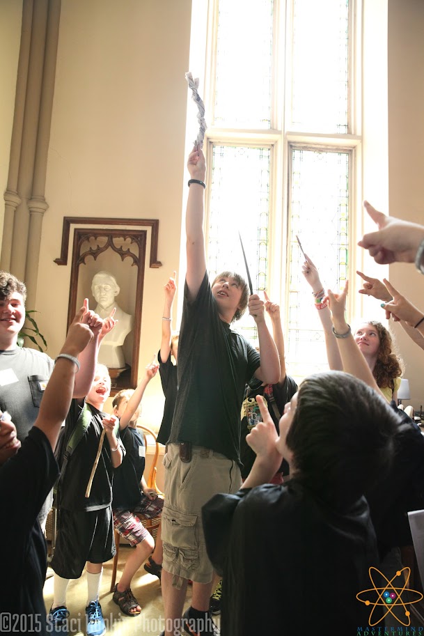 Students raising wands in celebration